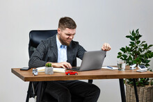 Man Sitting On Chair At Table And Resting, Using Laptop