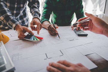 Engineers work as a team with blueprints for architectural plans. Engineer sketching construction project concept with architect equipment Architects talking at table Teamwork and construction concept