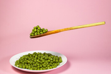 Canvas Print - Pickled green peas on a white plate on a pink background