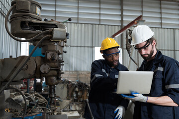 Wall Mural - Two male technician using laptop computer for checking lathe machine in factory, maintenance CNC machine in workshop