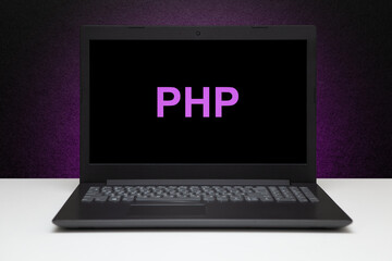 Wall Mural - PHP text on laptop screen on textured black background with purple light. Learn php programming language, computer courses, training.