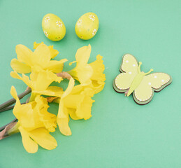 Wall Mural - Easter eggs, yellow daffodils flowers bunch, Spring season decoration on green