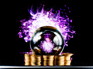 Crystal magical glass ball on stack of golden coins, abstract light painting on dark background. Forecasting money and profit gain. Financial sorcery. Foreseeing and predicting future economy turns