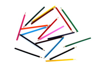 Colored pencils lie on a white isolated background from the top angle.	