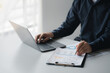 © PHOTO4U - Business man pointing to a pie chart document showing company financial information, He sits in her private office, a document showing company financial information in chart form. Financial concepts