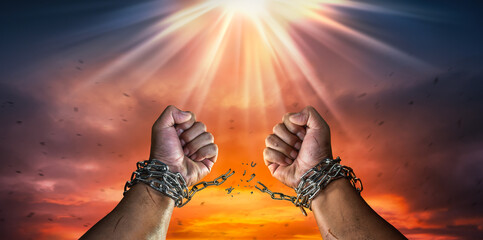 Hands in fists breaking a chain freedom. The concept of gaining freedom.