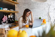 © ivanko80 - Woman in the kitchen working on laptop,having headache