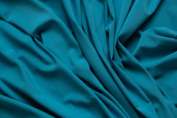 Wall Mural - Blue wrinkled plain fabric as background close-up