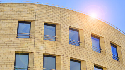 Wall Mural - Detail of a modern yellow brick building with large windows.