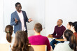 © JackF - African american male teacher lecturing to adult students at auditorium
