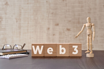 Poster - There is wood cube with the word Web3. It is eye-catching image.