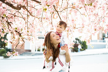 Mom with baby. A walk in the spring park. Family relationships.