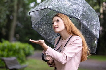 young woman under umbrella in rainy season