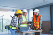 © NanSan - Group of multi ethnic engineer construction site worker meeting at workplace, Architects working together at construction site to remodeling home or building.