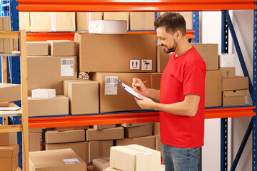 Poster - Post office worker with clipboard checking parcels at rack indoors