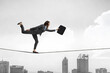 © Sergey Nivens - Image of businesswoman balancing on rope. Risk concept