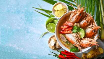 Shrimp soup on seafood soup bowl with thai herb and spices, Hot and sour spicy shrimps prawns soup  curry lemon lime galangal red chili straw mushroom on table food, Thai Food Tom Yum Kung