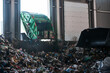 A garbage truck unloads household waste in the receiving chamber of a waste sorting plant