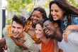 Close up portrait of a group of smiling multiracial teenage friends having fun outdoors. Cherful young people laughing together on vacation. Lifestyle concept. High quality photo
