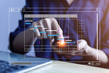 Fototapete - Male manager managing business planning project schedule in the office. Gantt chart showing on virtual screen.	