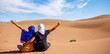 Happy couple tourist in the Sahara desert- Morocco