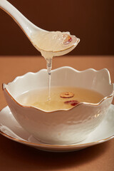 Canvas Print - Edible bird's nest soup with jujube in porcelain bowl, placed on a porcelain dish. Bird's nest soup is popular at Hong Kong, Taiwan, China and Southeast Asia. Good for people’s health