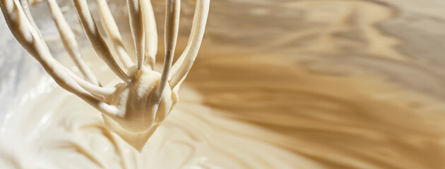 mixer whisk with dough for cheesecake, close-up, advertising banner concept