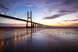 © Cavan Images - Vasco Da Gama bridge over Tagus River against sky during sunset