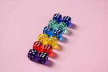Close-up Of Colorful Dice Arranged Over Pink Background