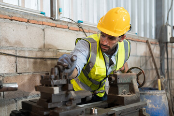 Wall Mural - Male engineer working with lathe machine in factory. Industry for manufacturing technology