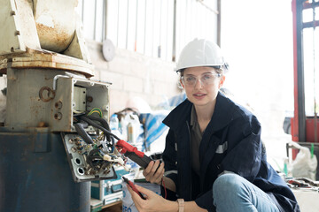 Aufkleber - Female electrician worker checking, repair, maintenance operation electric system of robotic arm in factory. Electrician using electrical meters working with operation electric system of robot arm