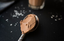 Close-up Of Chocolate Ice Cream In Spoon On Table