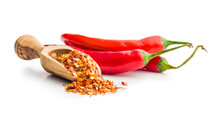 Dry Chili Pepper Flakes In Wooden Scoop. Crushed Red Peppers Isolated On White Background.