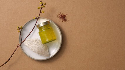 Wall Mural - Bird’s nest raw on round dishes and saffron (Crocus sativus) on brown background. Mockup scene for product of bird's nest distilled with saffron - herbs good for health. Top view, flat lay