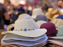 Women's Hats To Shelter From The Sun On The Beach, By The Sea. Many Hats Sold On Market Stalls In A Seaside Resort.