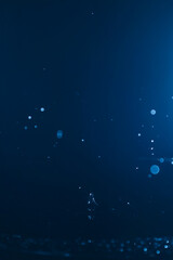 Blur abstract background with bokeh defocused lights and shadow. Blue water drops background. Trendy abstract nature background.