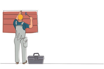 Poster - single continuous line drawing professional worker in uniform hammering. nail in wood. construction 