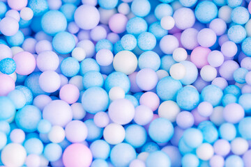 Wall Mural - Colorful balls background in pink and blue colors. Background with colorful balls in different sizes. Sphere of balls on pastel color.