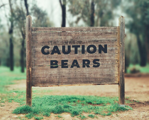 a forest wood sign with text saying Caution bears