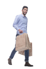 Wall Mural - happy man with shopping bags confidently striding forward.