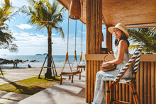 Traveler Asian Woman Travel And Relax On Swing In Beach Cafe At Koh Chang Summer Thailand