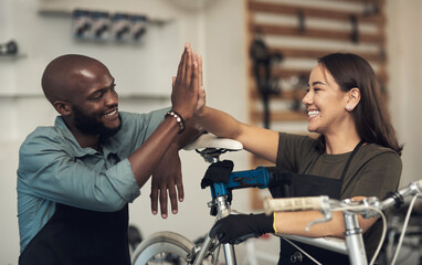 Aufkleber - Another repair done and dusted. Shot of two young business owners standing together in their bicycle shop and giving each other a high five.