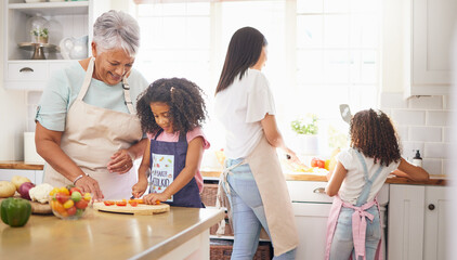 Poster - Black family cooking, children learning and grandmother teaching girl for healthy lunch and growth development in kitchen together. Senior woman and mom with kids make salad or vegetable food in home