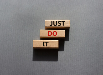 Wall Mural - Just do it symbol. Wooden blocks with words Just do it. Beautiful grey background. Business and Just do it concept. Copy space.
