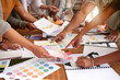 © Lune V A/peopleimages.com - Color design, creative and hands of business people on desk for branding meeting, strategy and marketing logo. Teamwork, collaboration and designers brainstorming ideas, thinking and project plan