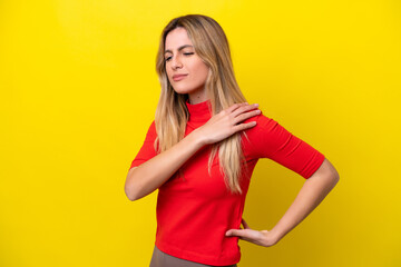 Wall Mural - Young Uruguayan woman isolated on yellow background suffering from pain in shoulder for having made an effort