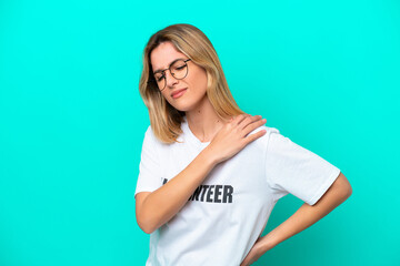 Wall Mural - Young volunteer Uruguayan woman isolated on blue background suffering from pain in shoulder for having made an effort