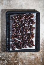 Baking Pan With Ripe Grapes On Parchment Paper