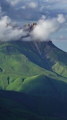 Wall Mural - beautiful landscape with mountains and clouds in dusk, caucasus, russia, zoom out timelapse. vertica