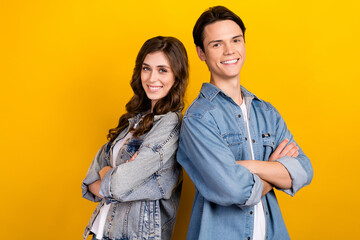Wall Mural - Photo of two cheerful nice people crossed hands beaming smile isolated on yellow color background